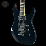 Black electric guitar on a black background with 'Tone Shop' logo.