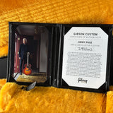 Gibson Custom Jimmy Page guitar with certificate of authenticity on a yellow textured surface