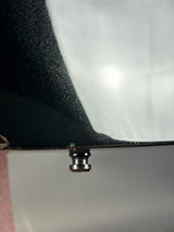 Close-up of a metal screw on a textured surface