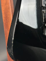 Close-up of a car's side mirror with a scratch on the surface