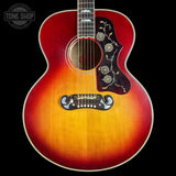 Acoustic guitar with sunburst finish on a black background, featuring 'Tone Shop' logo.