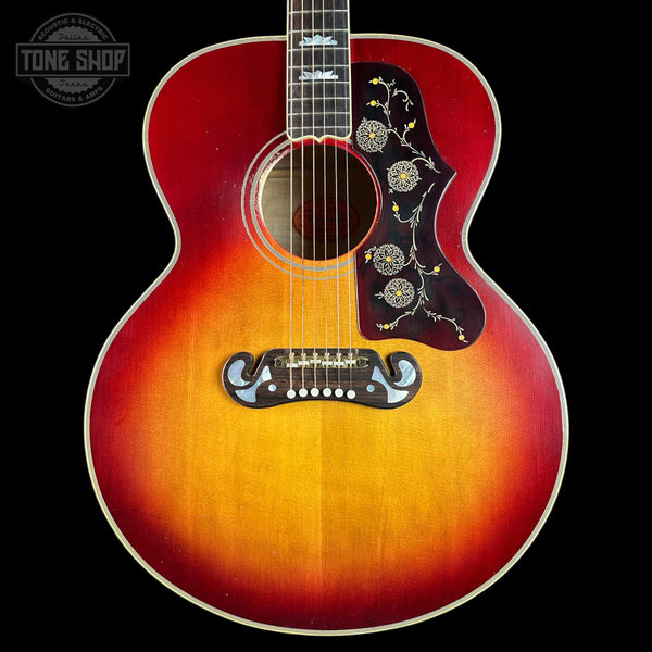 Acoustic guitar with sunburst finish on a black background, featuring 'Tone Shop' logo.