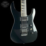 Black electric guitar on a black background with 'Tone Shop' logo.