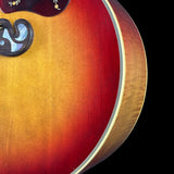 Close-up of a sunburst acoustic guitar on a black background