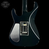 Close-up of a black electric guitar's back with a visible humbucker pickup, branded 'Tone Shop'.