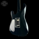 Black electric guitar with a clear pickguard on a black background, featuring 'Tone Shop' branding.