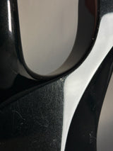 Close-up of a black and silver car mirror with visible wear.