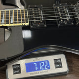 Electric guitar on a digital scale displaying weight