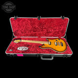Electric guitar in a red case with EVH logo, Tone Shop branding.