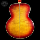 Close-up of a guitar's back with a visible brand logo in the corner.