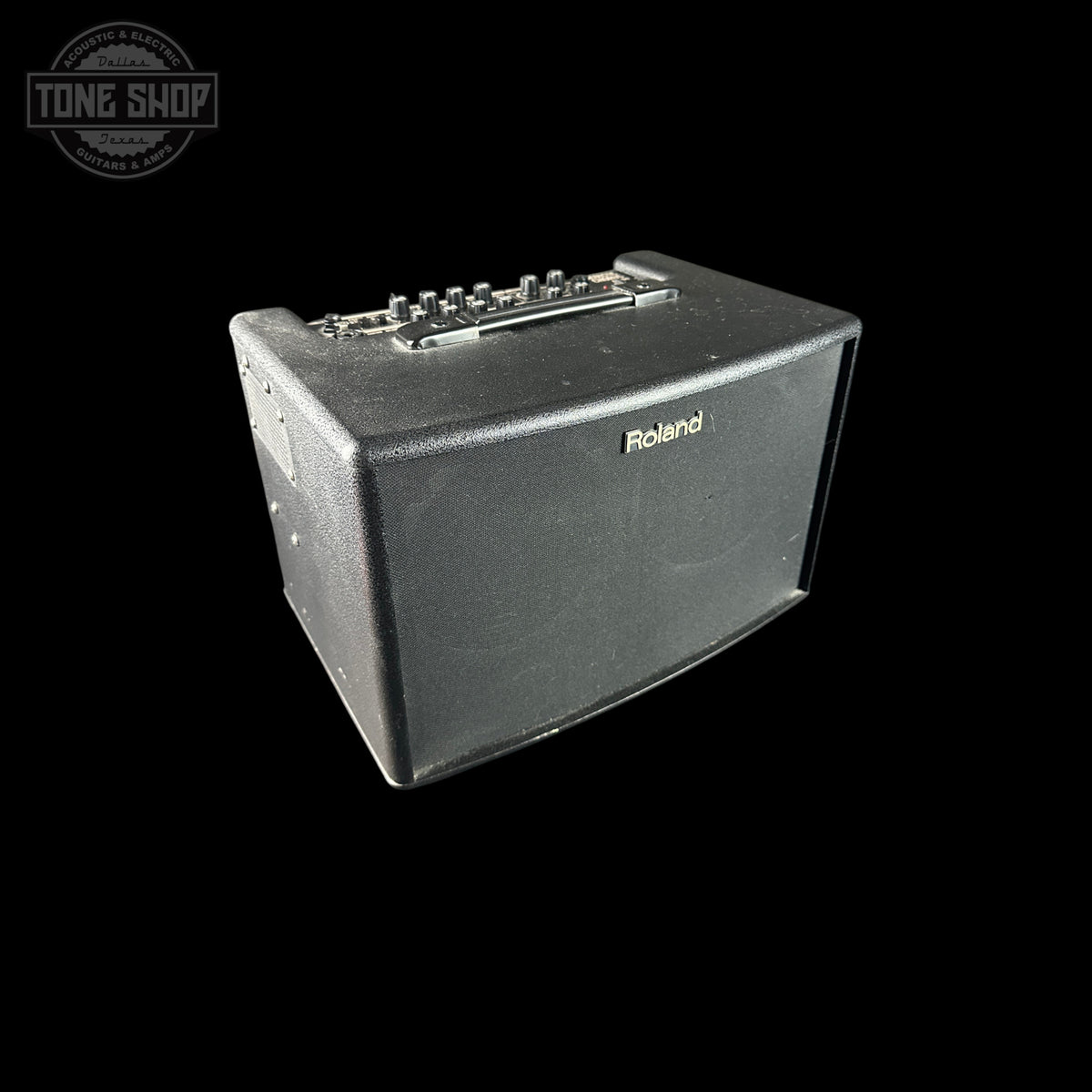 Roland guitar amplifier on a black background with 'Tone Shop' logo.