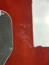Close-up of a metal object on a red surface with white paper