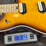 Electric guitar on a digital scale displaying weight