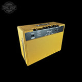 Yellow guitar amplifier with brand logo on a black background