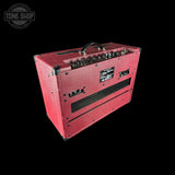 Red guitar amplifier with 'Tone Shop' logo in the corner
