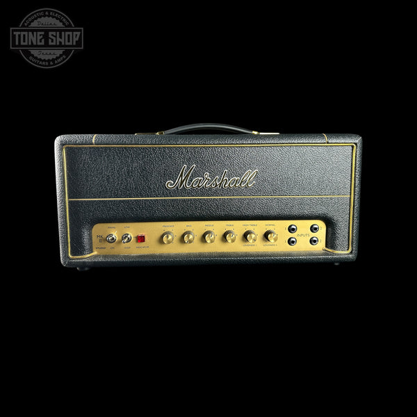 Marshall guitar amplifier head with gold accents on a black background