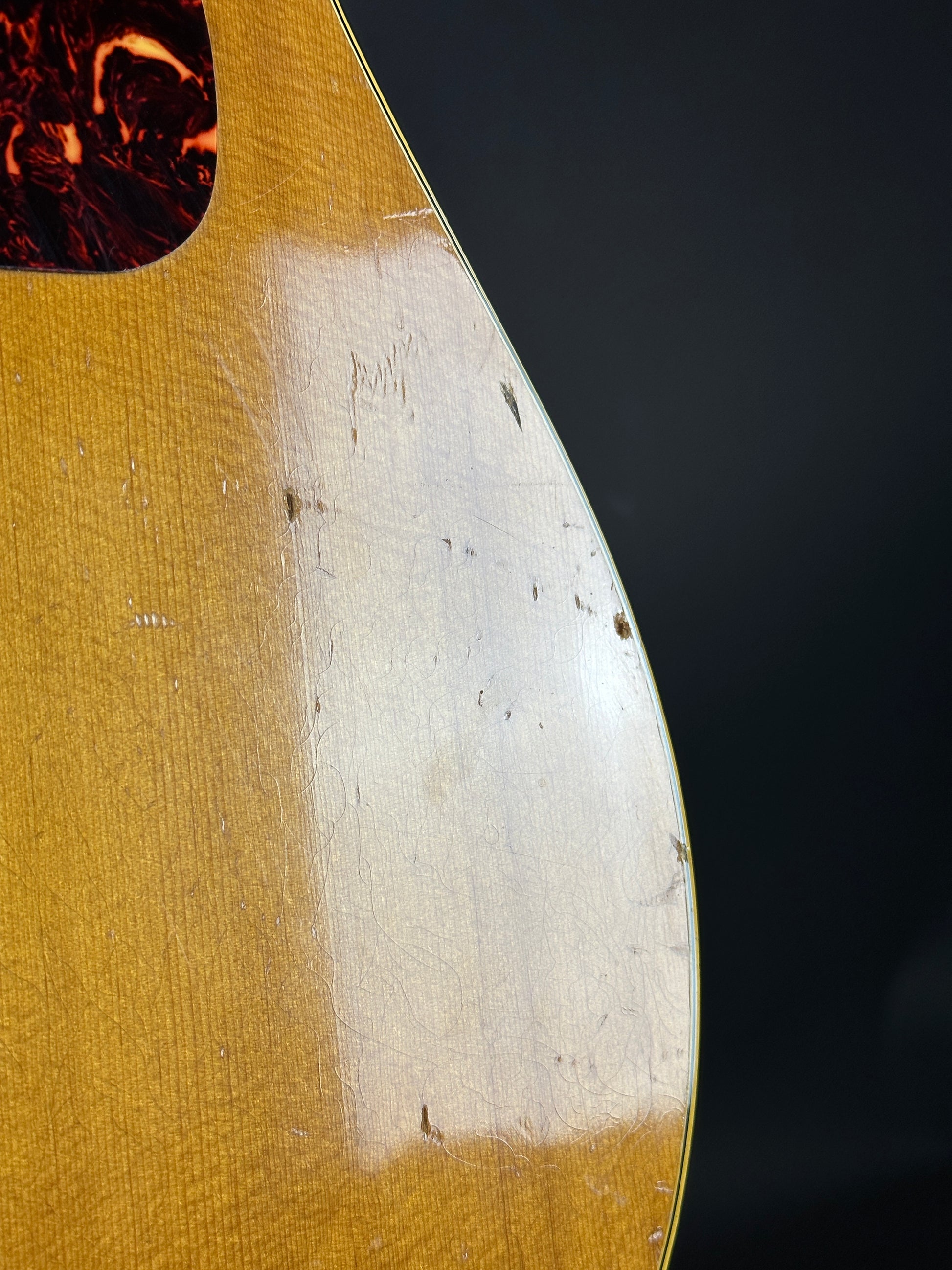 Close-up of a guitar's soundhole with a dark background