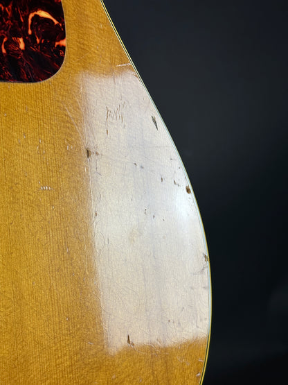 Close-up of a guitar's soundhole with a dark background
