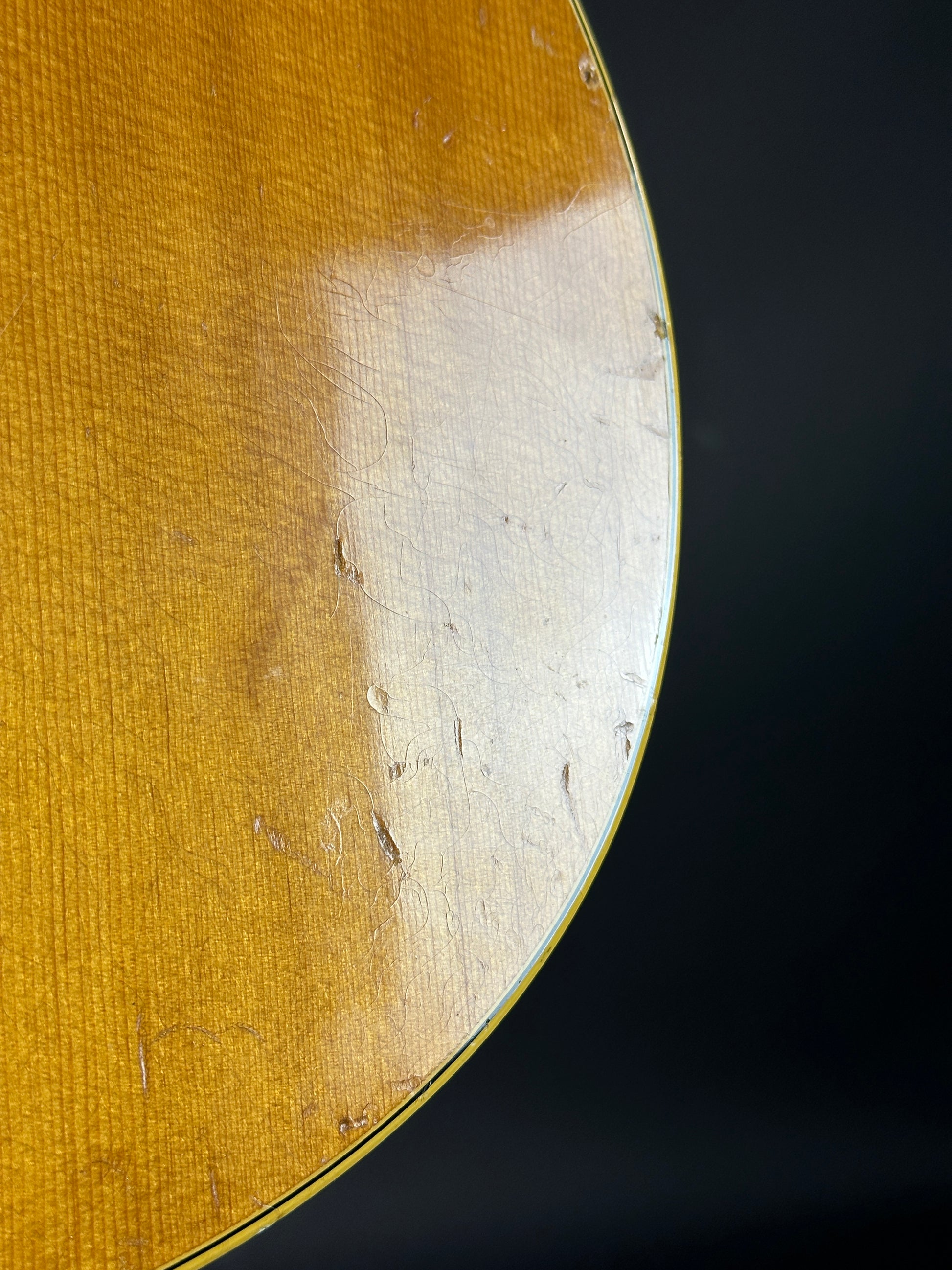 Close-up of a guitar's soundboard with a dark background
