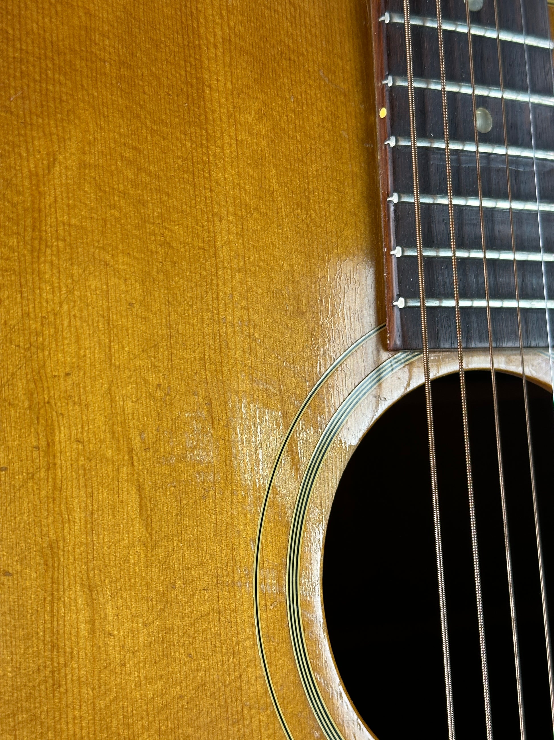 Close-up of a guitar's soundhole and fretboard