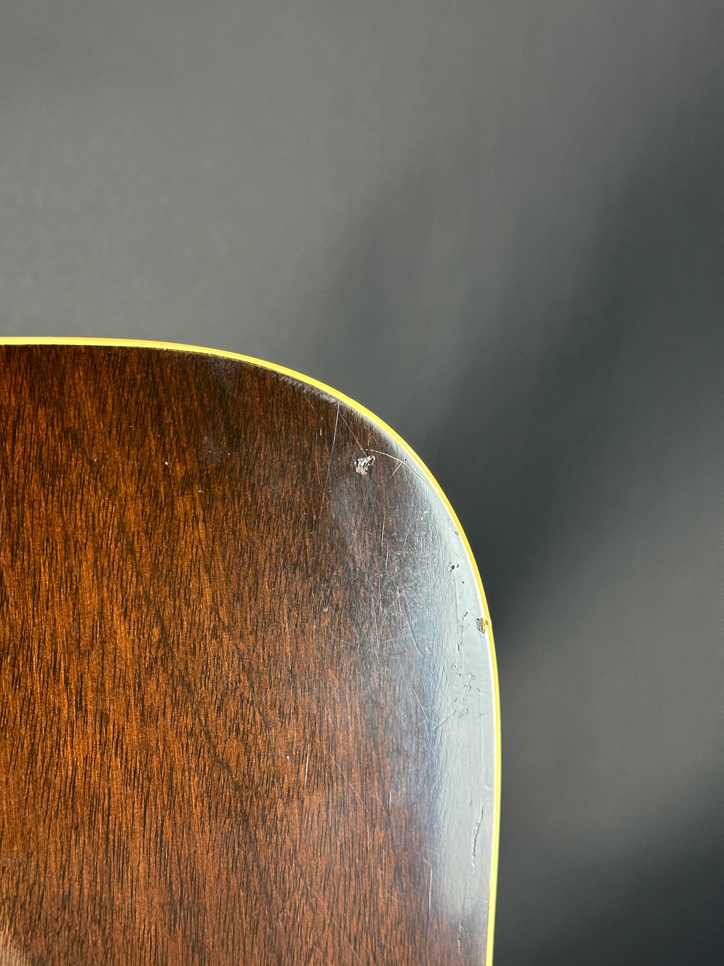 Close-up of a wooden surface with a dark gray background