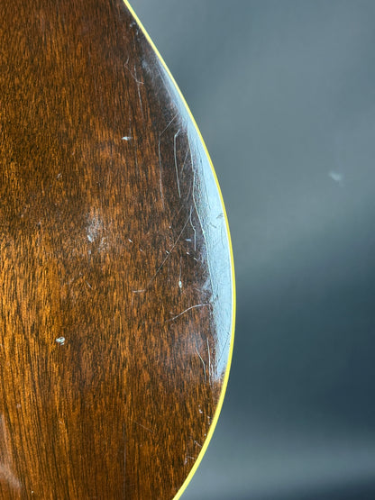 Close-up of a wooden surface with visible scratches and a dark background