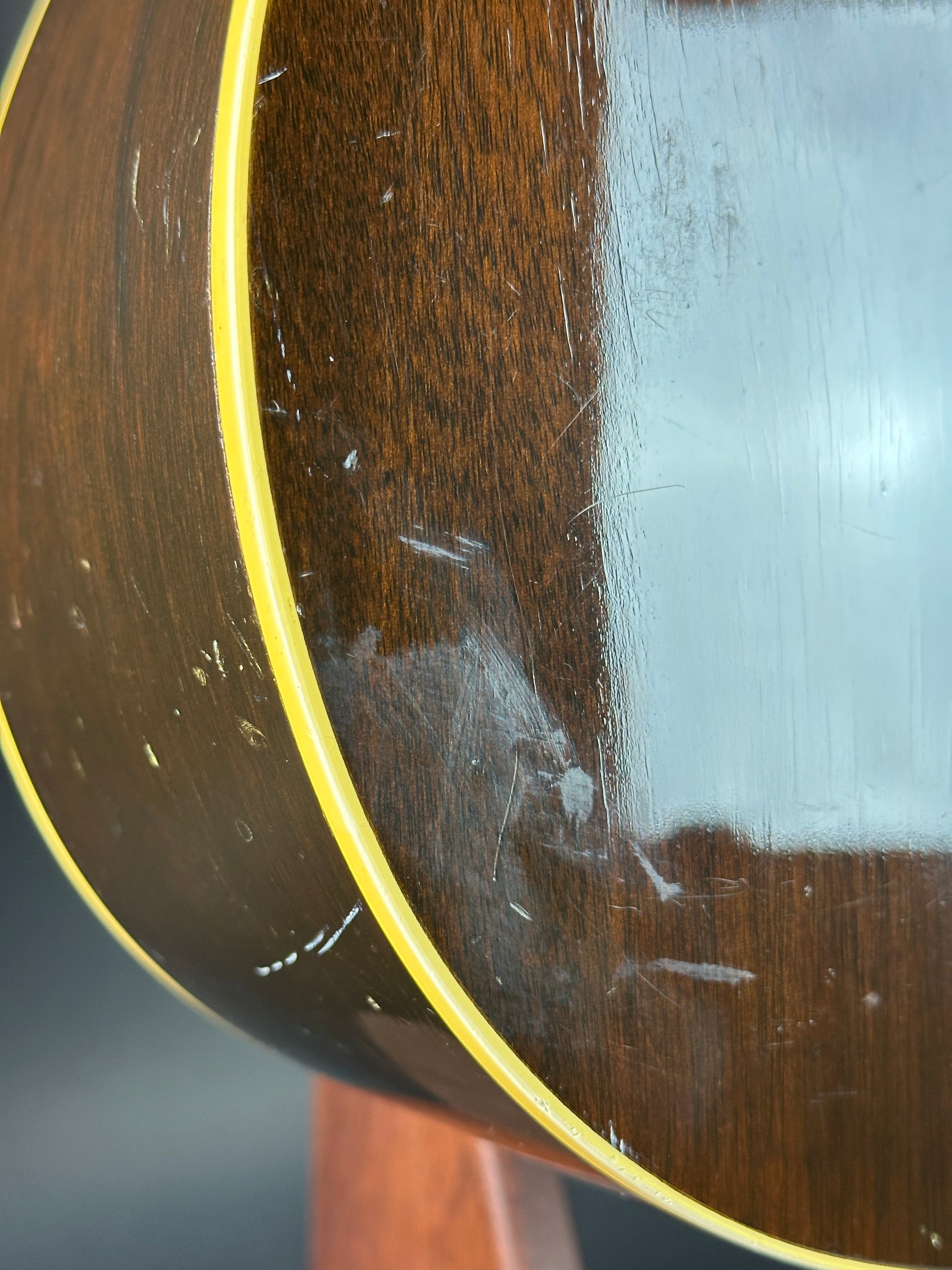 Close-up of a guitar's soundhole with visible wear and tear.