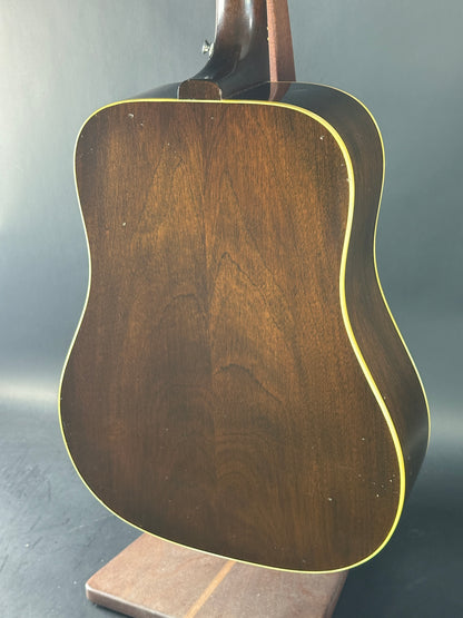 Close-up of a wooden acoustic guitar body on a dark background