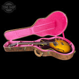 Guitar in a pink case with 'Tone Shop' logo in the corner