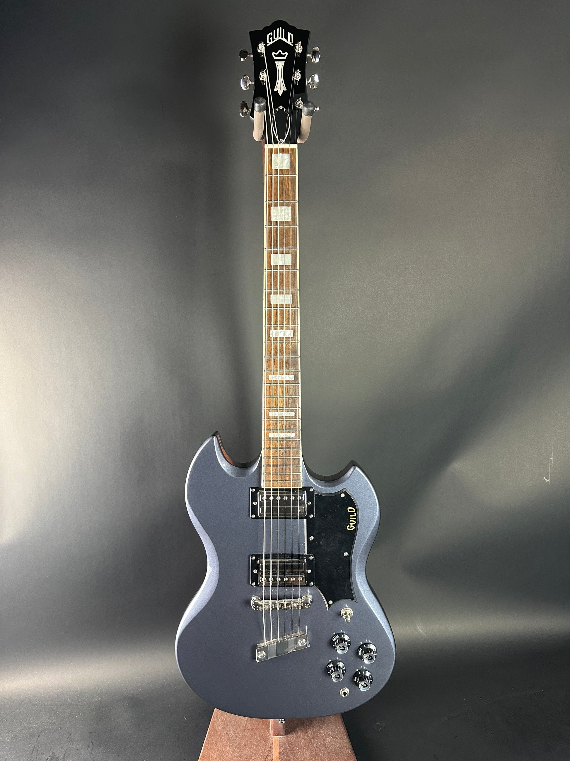 Electric guitar on a reflective gray surface
