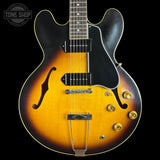 Electric guitar with a sunburst finish on a black background, featuring the Tone Shop logo.