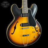 Electric guitar with a sunburst finish on a black background, featuring the Tone Shop logo.