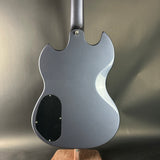 Back view of a gray electric guitar on a neutral background