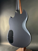Close-up of a guitar body with a metallic finish on a gray background