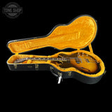 Gibson guitar in an open hardshell case with 'Tone Shop' logo.