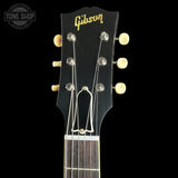 Gibson guitar headstock with brand logo on a black background
