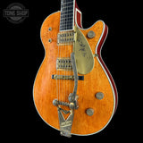 Electric guitar with a sunburst finish on a black background, featuring the Tone Shop logo.