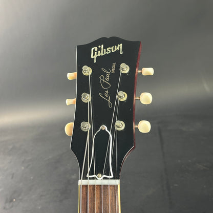 Gibson Les Paul guitar headstock on a dark background