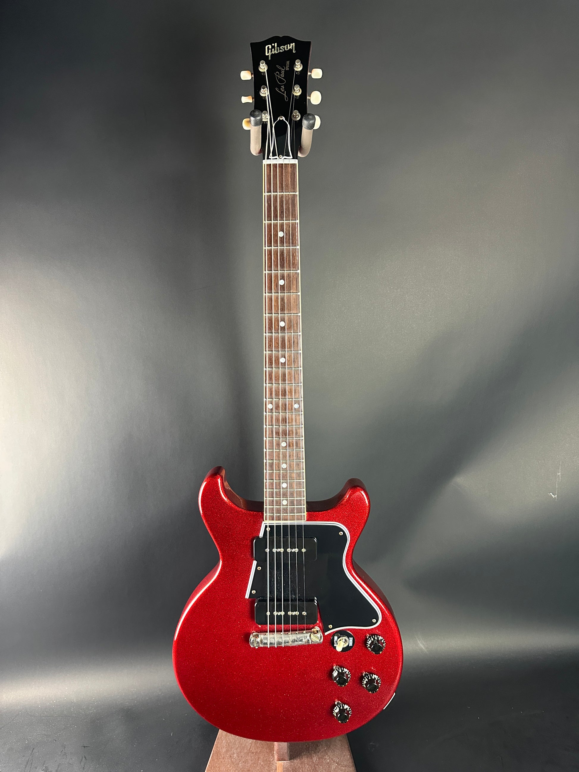 Red electric guitar on a gray background