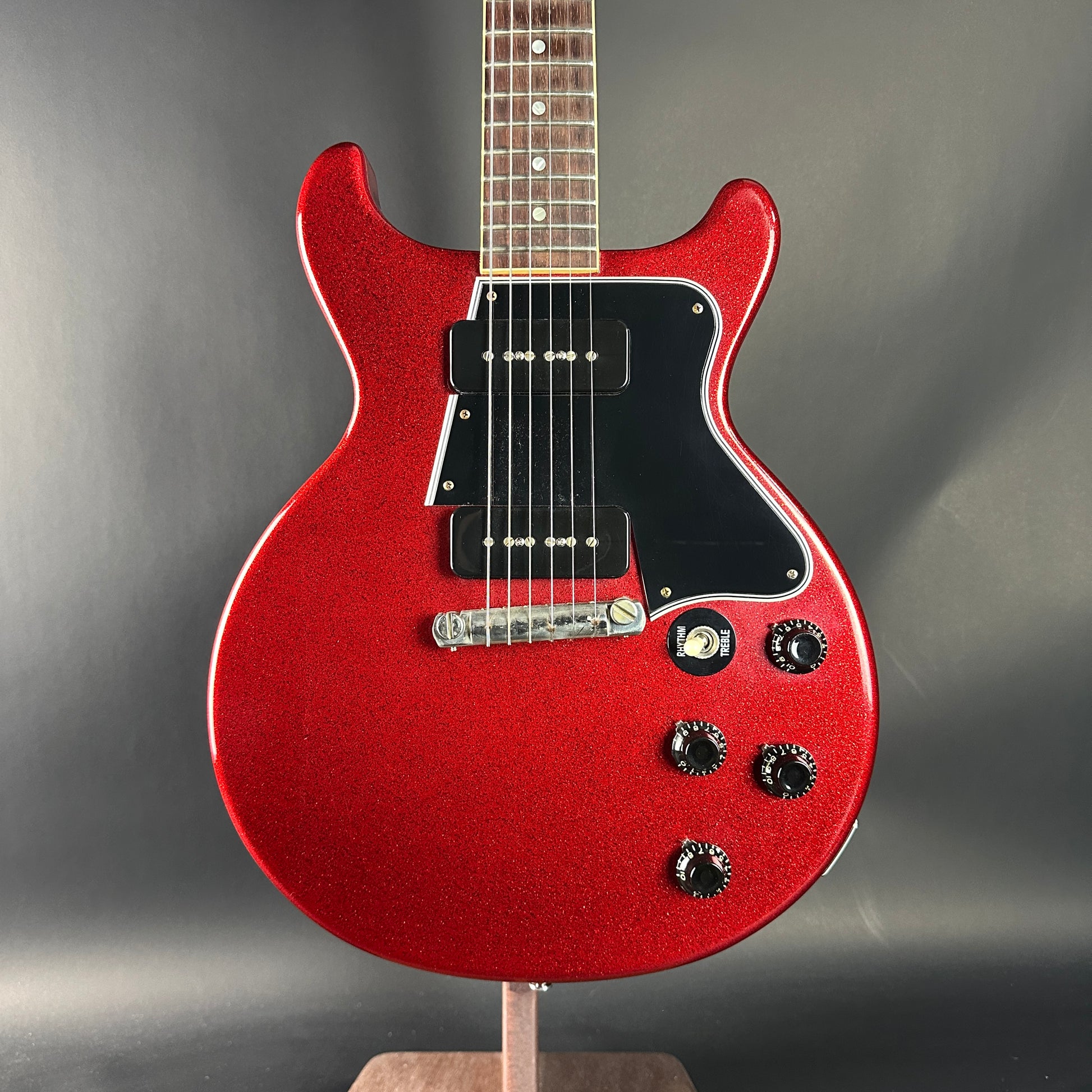 Red electric guitar on a gray background