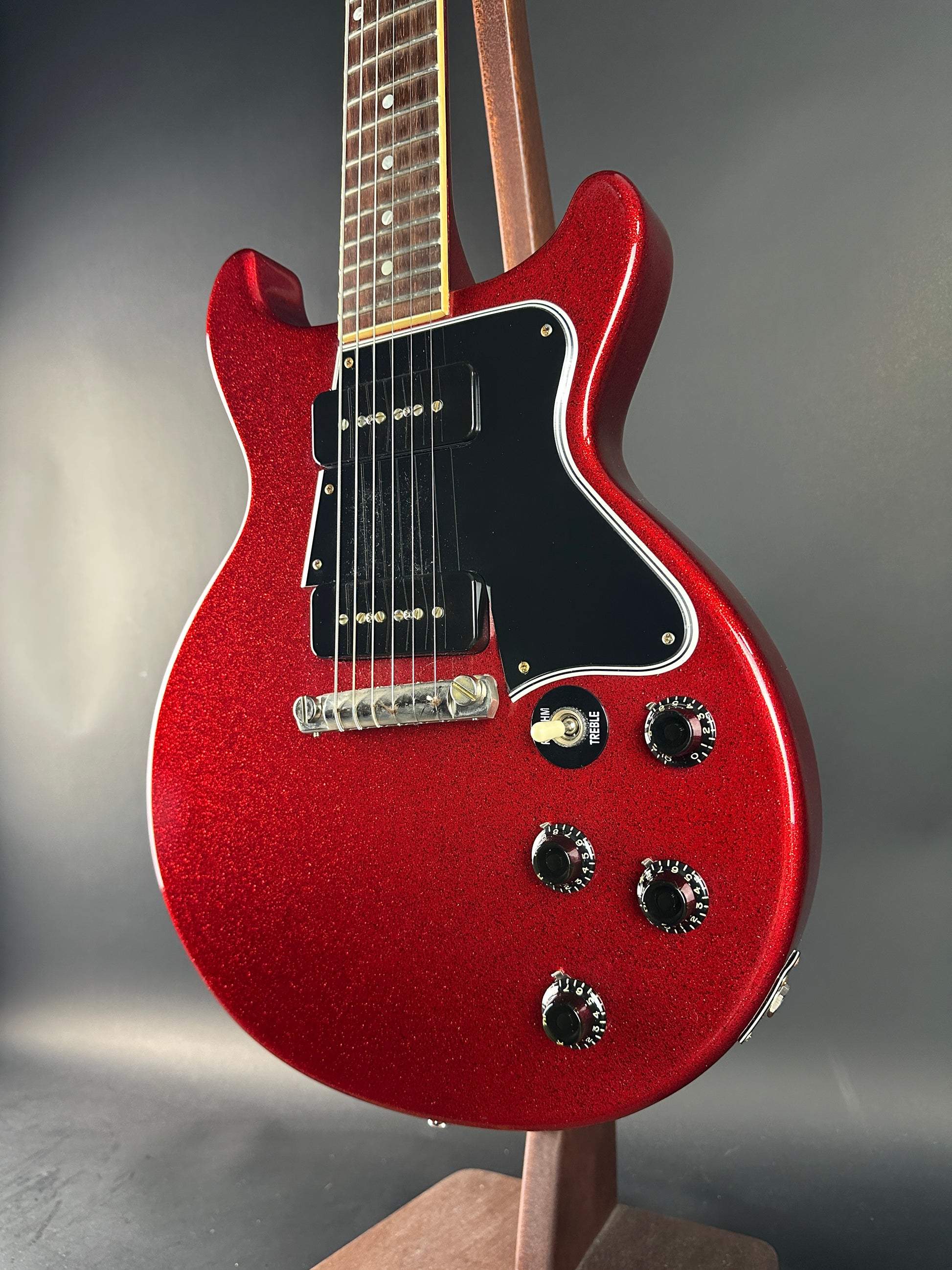 Red electric guitar on a gray background