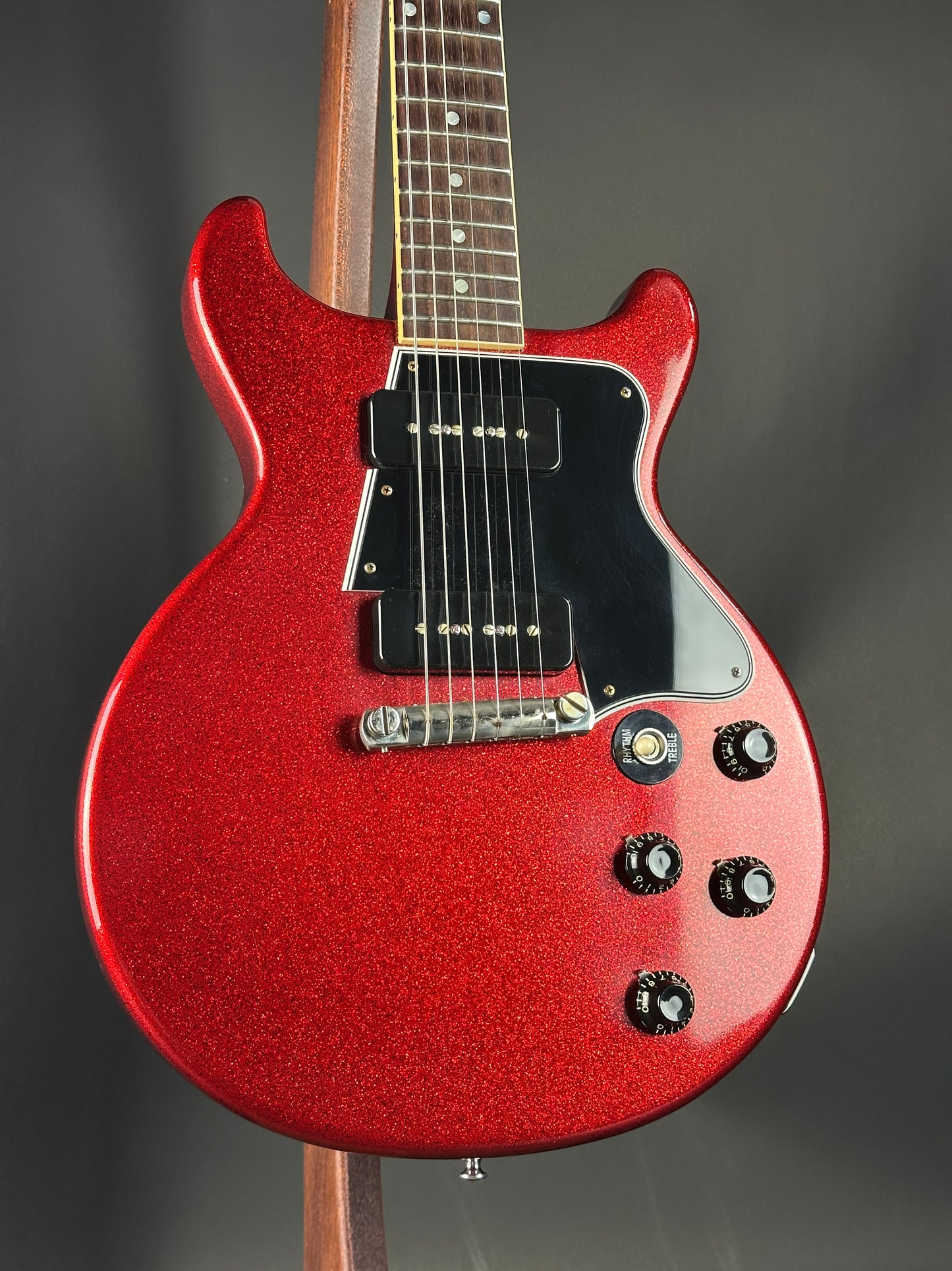 Red electric guitar on a dark background