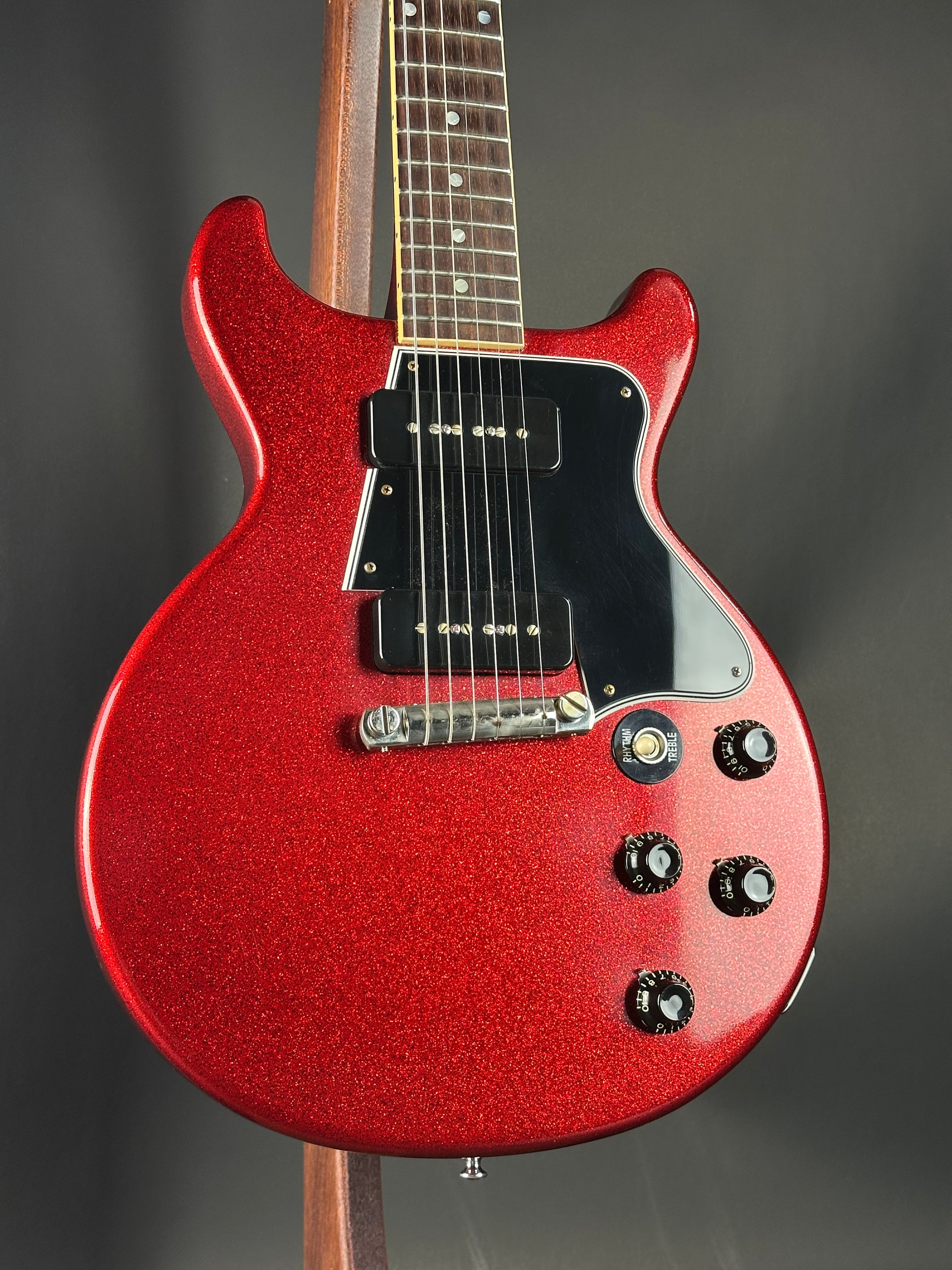Red electric guitar on a dark background