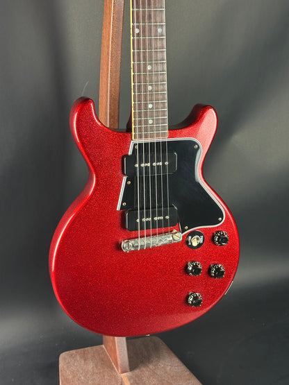 Red electric guitar on a dark background