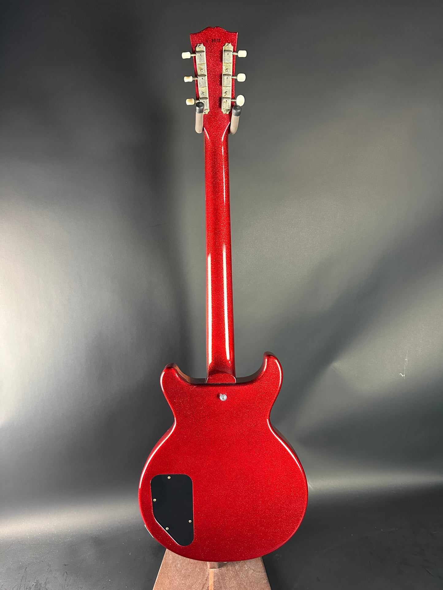 Red electric guitar on a gray background