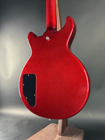 Red electric guitar on a gray background