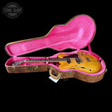 Guitar in a pink-lined case with 'Tone Shop' logo in the corner.