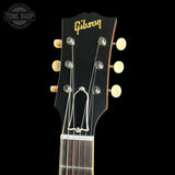 Gibson guitar headstock with brand logo on a black background