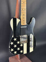Guitar with American flag design on a dark background