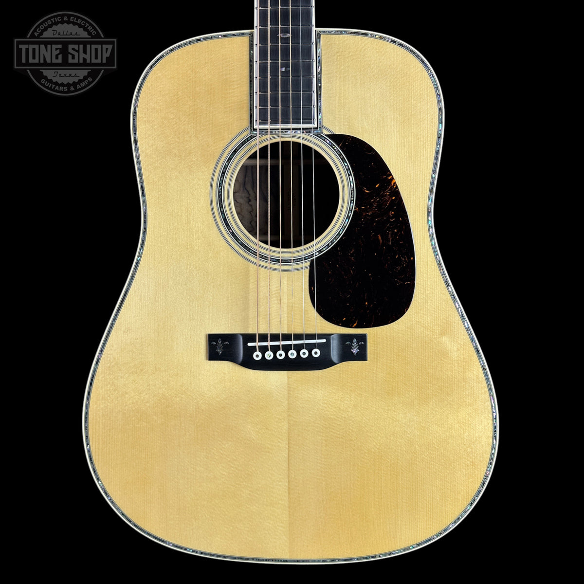 Acoustic guitar with a visible brand logo in the corner